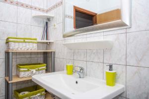 a bathroom with a sink and a mirror at Apartment in Njivice/Insel Krk 13321 in Njivice