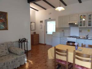 a kitchen and living room with a table and a couch at Holiday home in Rovinj/Istrien 11494 in Kokuletovica