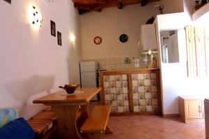 a room with a table and a kitchen with a table and a table at One-Bedroom Holiday Home in Povile I in Povile