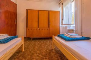 a room with two beds and a cabinet and a window at Three-Bedroom Apartment in Crikvenica XIII in Sopaljska