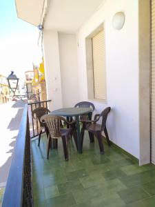 a patio with tables and chairs on a balcony at VFT Doña Elvira in Arjonilla