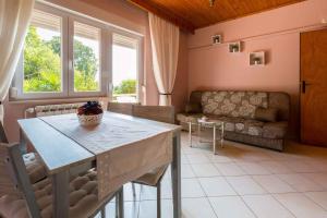 a living room with a table and a couch at One-Bedroom Apartment in Crikvenica XVIII in Dramalj