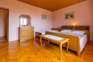 a bedroom with two beds and a table in it at One-Bedroom Apartment in Crikvenica XVIII in Dramalj