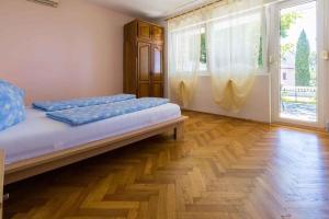 a bedroom with a bed and a large window at Three-Bedroom Holiday Home in Crikvenica II in Sopaljska
