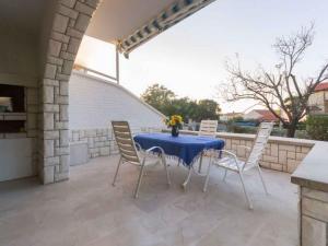a blue table and chairs on a patio at Apartment in Njivice/Insel Krk 13305 in Njivice