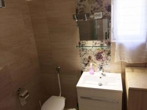 a small bathroom with a sink and a toilet at Holiday home in Siofok - Balaton 19801 in Siófok +18 photos