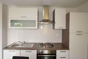a kitchen with a sink and a stove top oven at Apartment in Silo with One-Bedroom 10 in Šilo