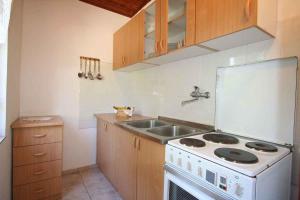 a kitchen with a white stove and a sink at Apartment in Silo/Insel Krk 14461 in Šilo