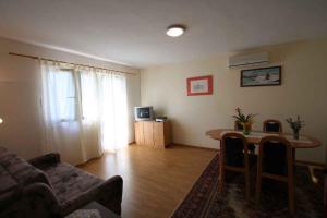 a living room with a couch and a table at Apartment in Silo/Insel Krk 14461 in Šilo