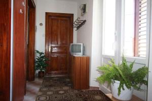 a hallway with a door and a tv on a table at Apartment in Silo/Insel Krk 13547 in Šilo