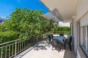 a patio with a table and chairs on a balcony at Apartment in Crikvenica 5555 in Dramalj