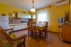 a kitchen and dining room with a table and chairs at Apartment in Crikvenica 5555 in Dramalj