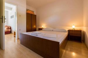 a bedroom with a large bed with two night stands at Apartment in Crikvenica with One-Bedroom 6 in Dramalj