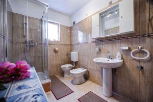 a bathroom with a sink and a toilet and a shower at Apartment in Rovinj/Istrien 11561 in Štanga