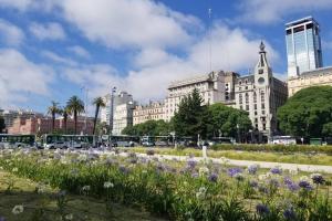 a field of flowers with buildings in the background at Corazón Porteño in Buenos Aires