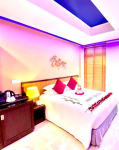 
a bedroom with a large bed and a large window at Eleven Trees Maldives in Male City
