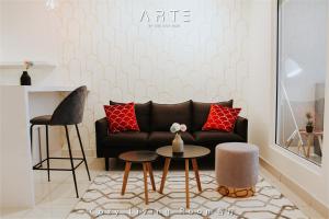 a living room with a couch and a table at Arte Mont Kiara Luxury Suite with Heated Jacuzzi Pods - Free Parking - Next to MITEC- by The Stay Hub in Kuala Lumpur
