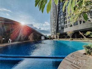 a large swimming pool in front of a building at Arte Mont Kiara Luxury Suite in Kuala Lumpur