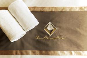 a towel and a napkin with a diamond on a bed at Tsun Huang Hotel in Chiayi City