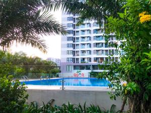 a hotel with a swimming pool in front of a building at Ecobay Halong -Mountain view and near Marina beach in Ha Long