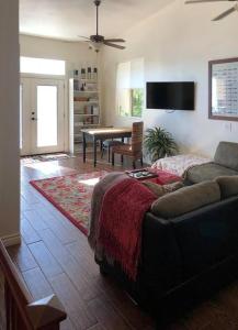 ein Wohnzimmer mit einem Sofa und einem Tisch in der Unterkunft Beautiful new detached casita nestled in scenic southern CA foothills! in Fallbrook