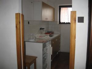 a small kitchen with a sink and a counter at Penzion Važec in Važec