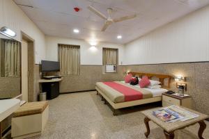 a hotel room with a bed and a flat screen tv at Hotel Royal Castle in Mumbai