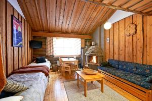 ein Wohnzimmer mit einem Sofa und einem Kamin in der Unterkunft Ski-inn kelohuoneisto Pyhätunturissa in Pelkosenniemi