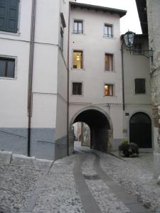 a building with an archway next to a street at Gastaldaga in Cividale del Friuli