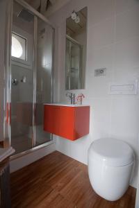 a bathroom with a red sink and a shower at Torre Antica - Lombardia, Italy in Lovere