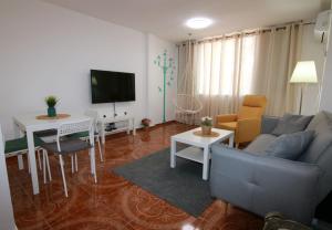 a living room with a couch and a table at עדן במדבר - eden in desert in Yeroẖam