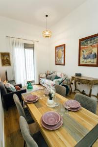 a living room with a wooden table with plates on it at Modern with swimming pool- 1Bd 1Bth- Goyeneta in Seville