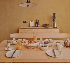 une table avec des assiettes et des ustensiles en haut dans l'établissement Älmele - Waldchalets Brandnertal, à Brand