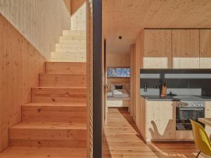 a staircase leading to the kitchen of a house at Älmele - Waldchalets Brandnertal in Brand