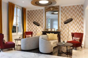 a living room with a couch and two chairs and a mirror at Ch&acirc;teau Belmont Tours by The Crest Collection in Tours