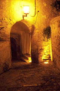 an alley with a light in a stone building at night at La Casa di Gino in San Nicola