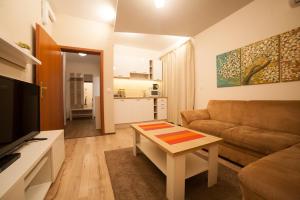 a living room with a couch and a coffee table at Апартамент ГАЛИ in Pleven