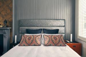 a bedroom with a large bed with two pillows at Dunstan Times in Clyde