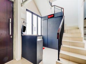 an elevator in a building with a staircase and a door at OYO 90215 Ada Residence in Poponcal 2