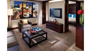 a living room filled with furniture and a tv at Mandarin Oriental Jakarta in Jakarta