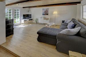 ein Wohnzimmer mit einem Sofa und einem TV in der Unterkunft fewo1846 - Villa Windschief - uriges Fachwerkhaus auf 3 Ebenen mit Garten im Stadtzentrum in Flensburg