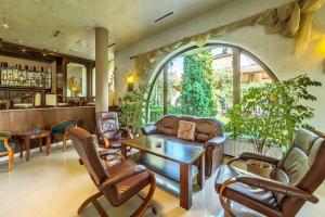 a living room with a couch and chairs and a table at Boutique Hotel L do Rado in Sofia