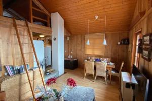 a living room with a table and a dining room at Magic Ski-In-And-Out Chalet above Verbier in Bagnes
