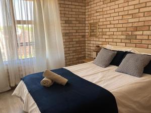 a bedroom with a bed with towels on it at 28 Kabeljauws in Jeffreys Bay +44 photos