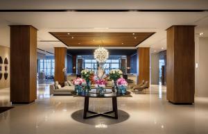 a lobby with a table with flowers on it at Hotel Ambasador - Liburnia in Opatija