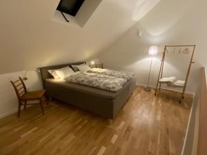 ein Schlafzimmer mit einem Bett, einem Stuhl und einer Lampe in der Unterkunft Zachhof Niederleierndorf in Langquaid