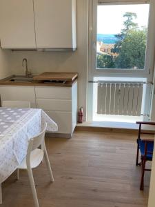 a kitchen with a table and a sink and a window at Guido's Apartment Villa Romana in Desenzano del Garda