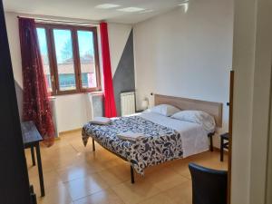 a bedroom with a bed and a large window at La Boheme Hotel in Turin