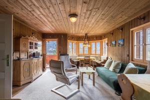 a living room with a couch and a table at Haus Löweneck in Bayrischzell