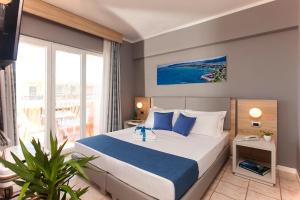 a bedroom with a large bed and a large window at Bike&Boat Argentario Hotel in Porto Santo Stefano